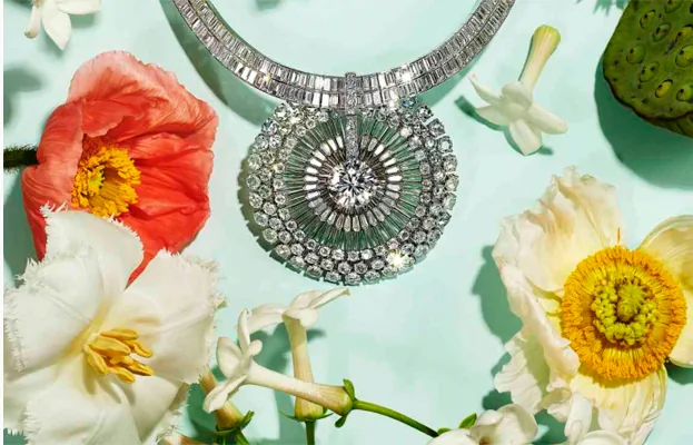 A diamond necklace on a pale ground with poppies and peonies