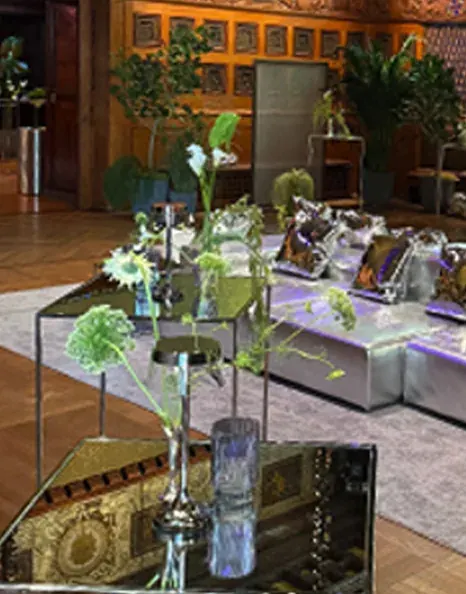 Delicate green floral arrangements across the wood-paneled lounge.