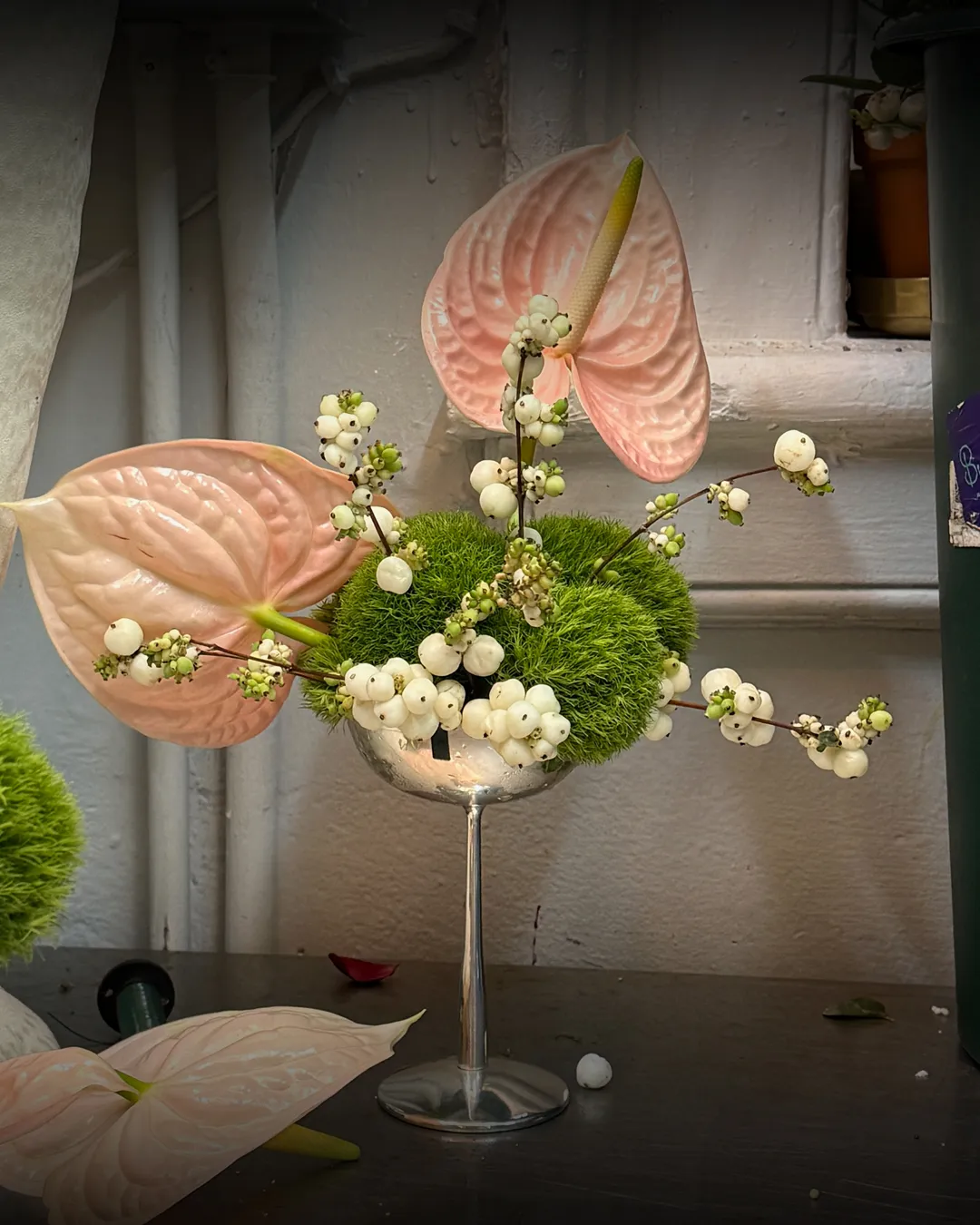 A coupe arrangement of pink anthurium, green dianthus and snowberry, composed at the Buunch atelier in Manhattan