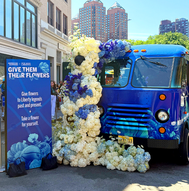Blue truck wrapped in white and blue hydrangeas outside the American Museum of Natural History