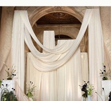 Draped wedding installation with white columns