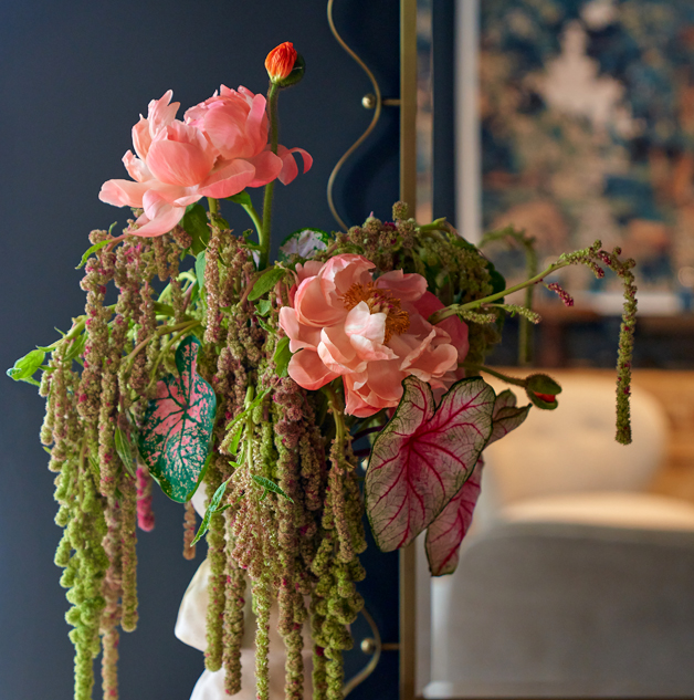 Hanging amaranthus and peonies in a navy interior