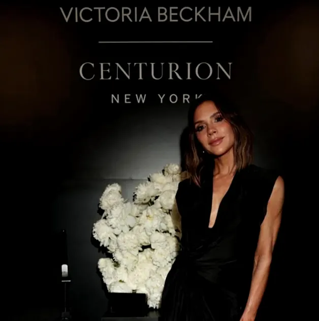 Victoria Beckham at the Centurion New York launch beside a white floral wall
